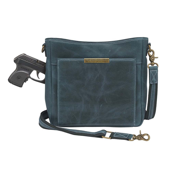Distressed blue Gun Tote'N Mamas Slim Crossbody Concealed Carry Purse with front gun compartment and shoulder strap.