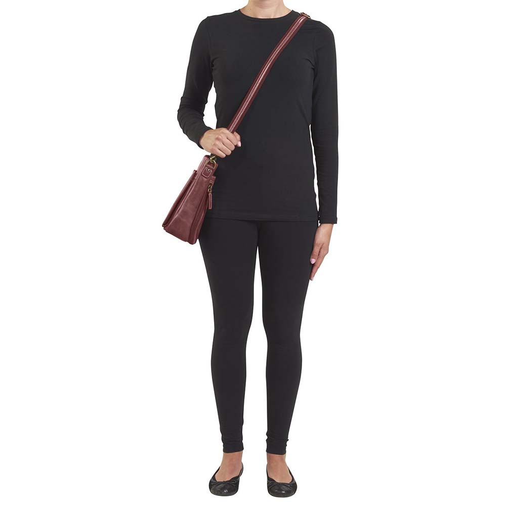 Red distressed leather concealed carry crossbody purse with RFID-secured card slots, top-draw access for right or left hand, fits compact pistols like Glock 26 or HK VP9, slash-resistant adjustable strap.