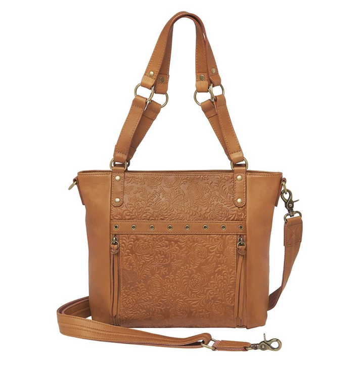 Tan concealed carry BOHO tote purse with top-access CCW compartment, symbolic butterfly and flower debossed leather, slash-proof straps, RFID-blocking zip pocket, and room for compact pistols like CZ P10, M&P Shield, and S&W EZ—each bag uniquely aged from natural tanning.