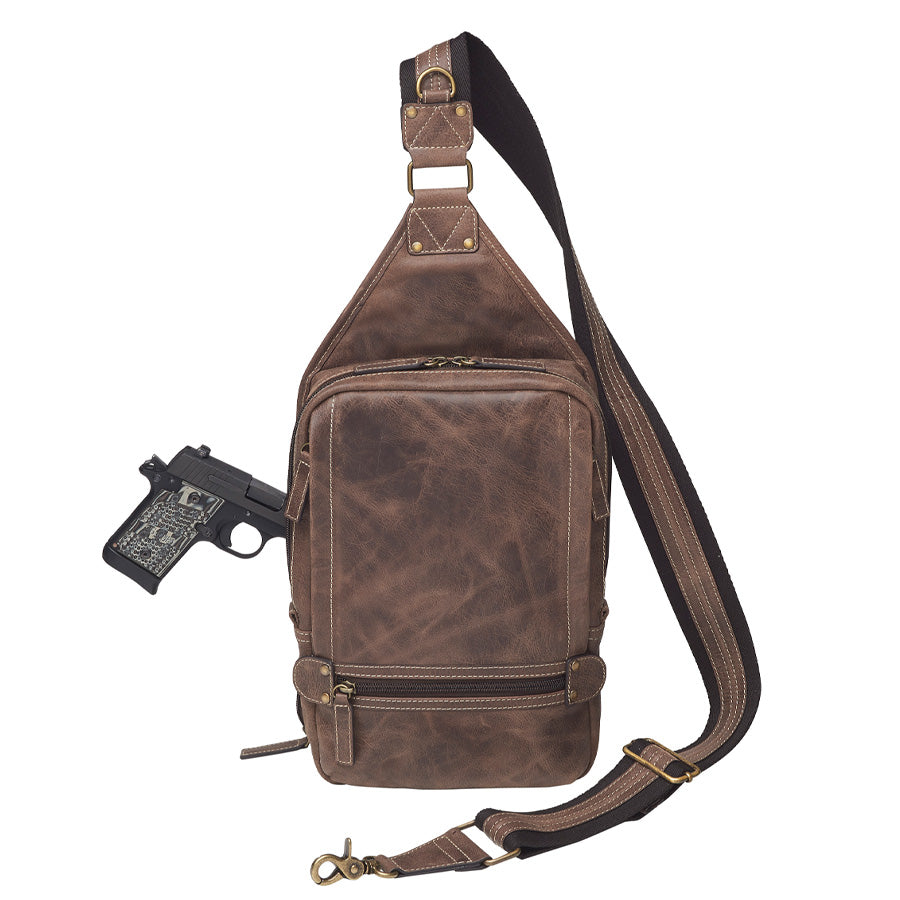 Distressed brown buffalo leather sling concealed carry backpack with tactical organization, RFID zip pocket, padded holster compartment for Glock 19, Sig P320, and HK VP9, slash-proof strap, and swing-front crossbody design with 3 exterior zip pockets and morale patch zone